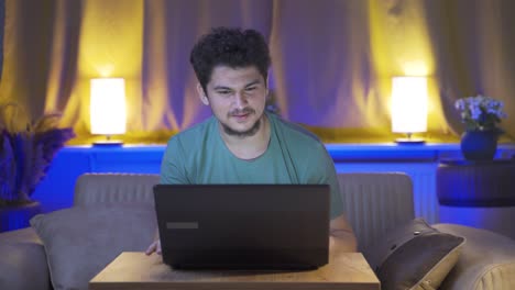 Happy-man-using-laptop-at-night.